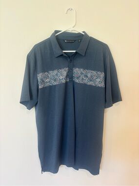 Travis Mathew Blue Polo with Floral Chest Band